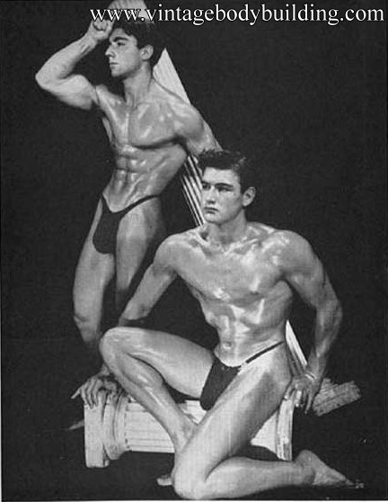 two vintage bodybuilders posing together