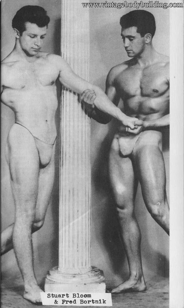 two muscle men posing together